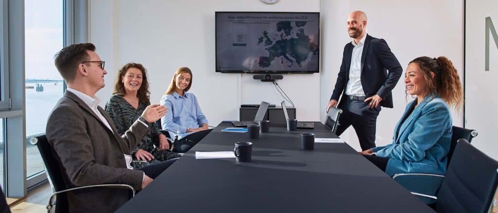 Five business people in meeting room in Abacus Medicine's headquarters in Copenhagen